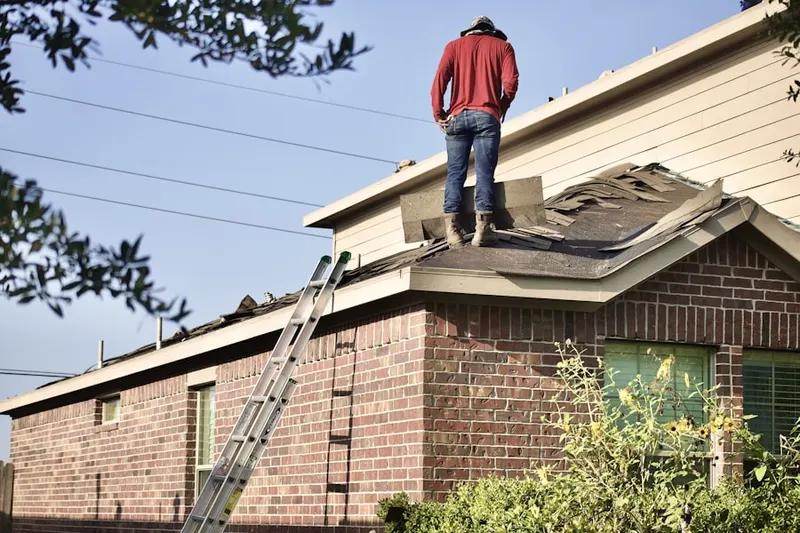 Professional roofer working on a residential roof in Amity Gardens